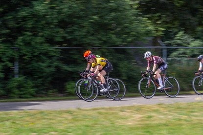 Three cyclists racing on a track during Dames ronde van Deventer.