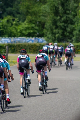 A group of women on bicycles taking part in the Dames ronde van Deventer cycling race.