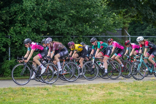 A group of women race on bicycles at the Dames ronde van Deventer.