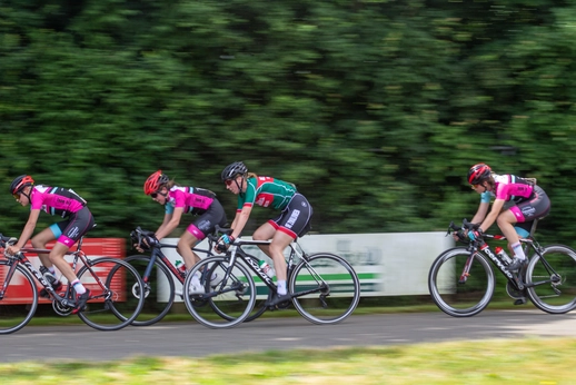 A group of cyclists race down a road during the Dames ronde van Deventer.