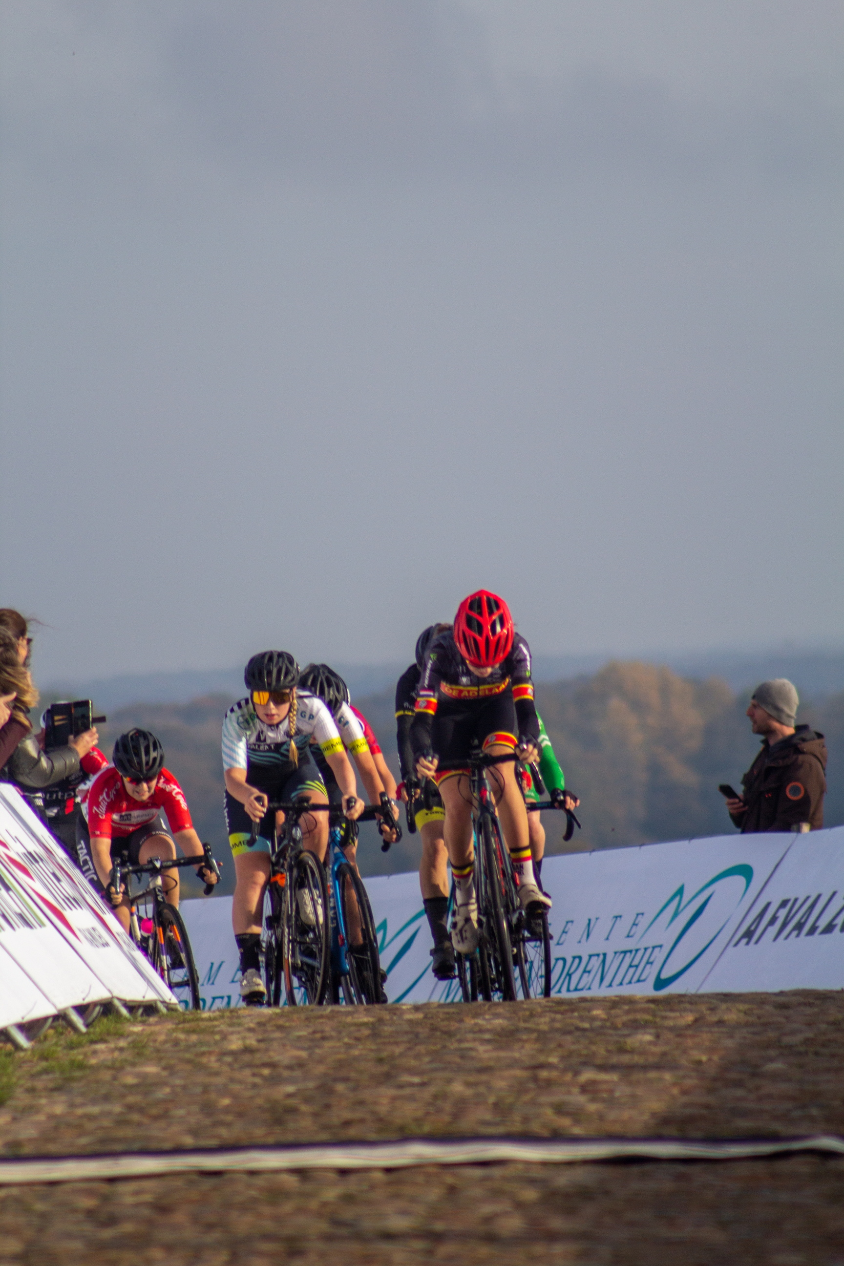 A group of cyclists riding in a race sponsored by NK Nieuweling.