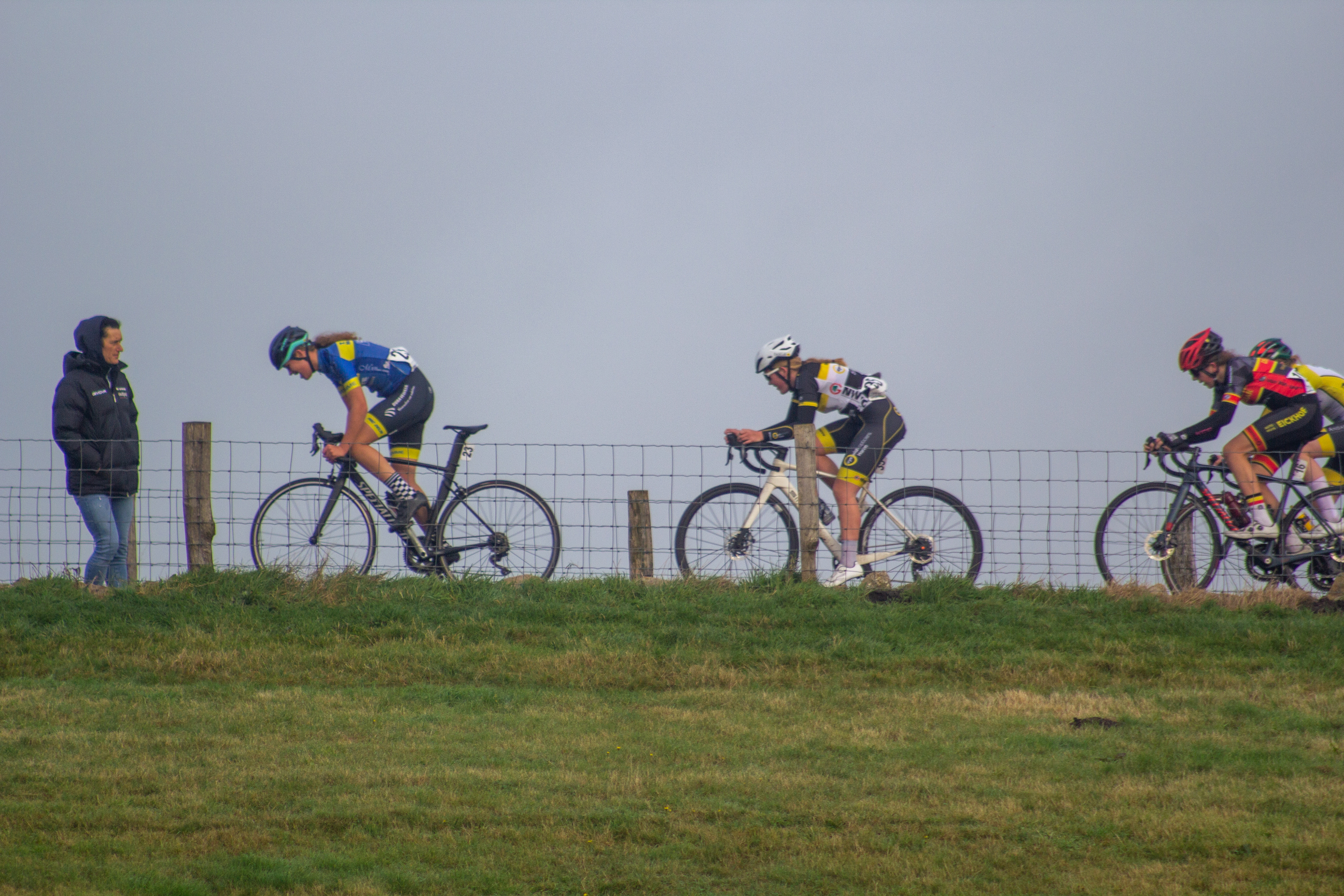 A group of people are riding bikes on a grassy field.