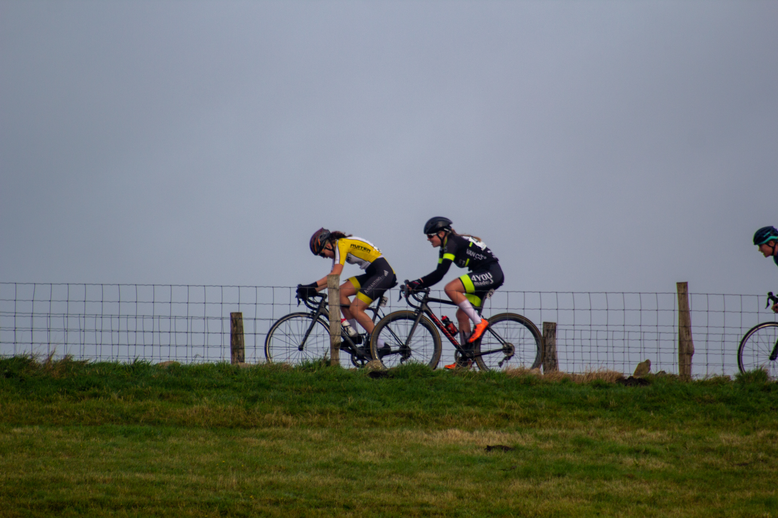 A cyclist is riding a bike with the number 10 on it.