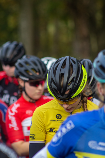 A person is seen with a yellow shirt that says NK Nieuweling on it.