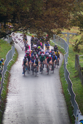 A group of people on bicycles in a competition sponsored by NK.