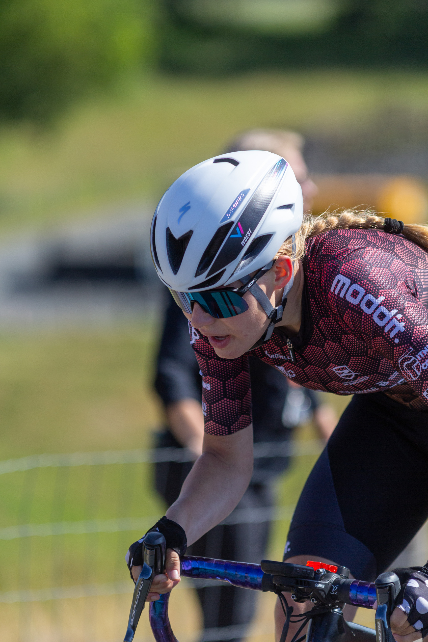 A woman on a bicycle with the word modif written across her chest.