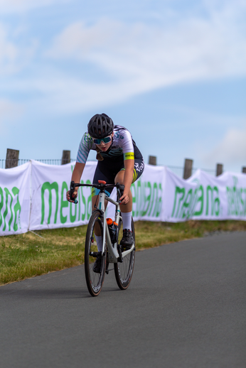 A person is riding a bike next to a banner that says "Mediaset".