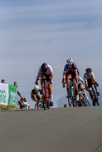 A group of cyclists race down a road in the town of Nieuwelingen.