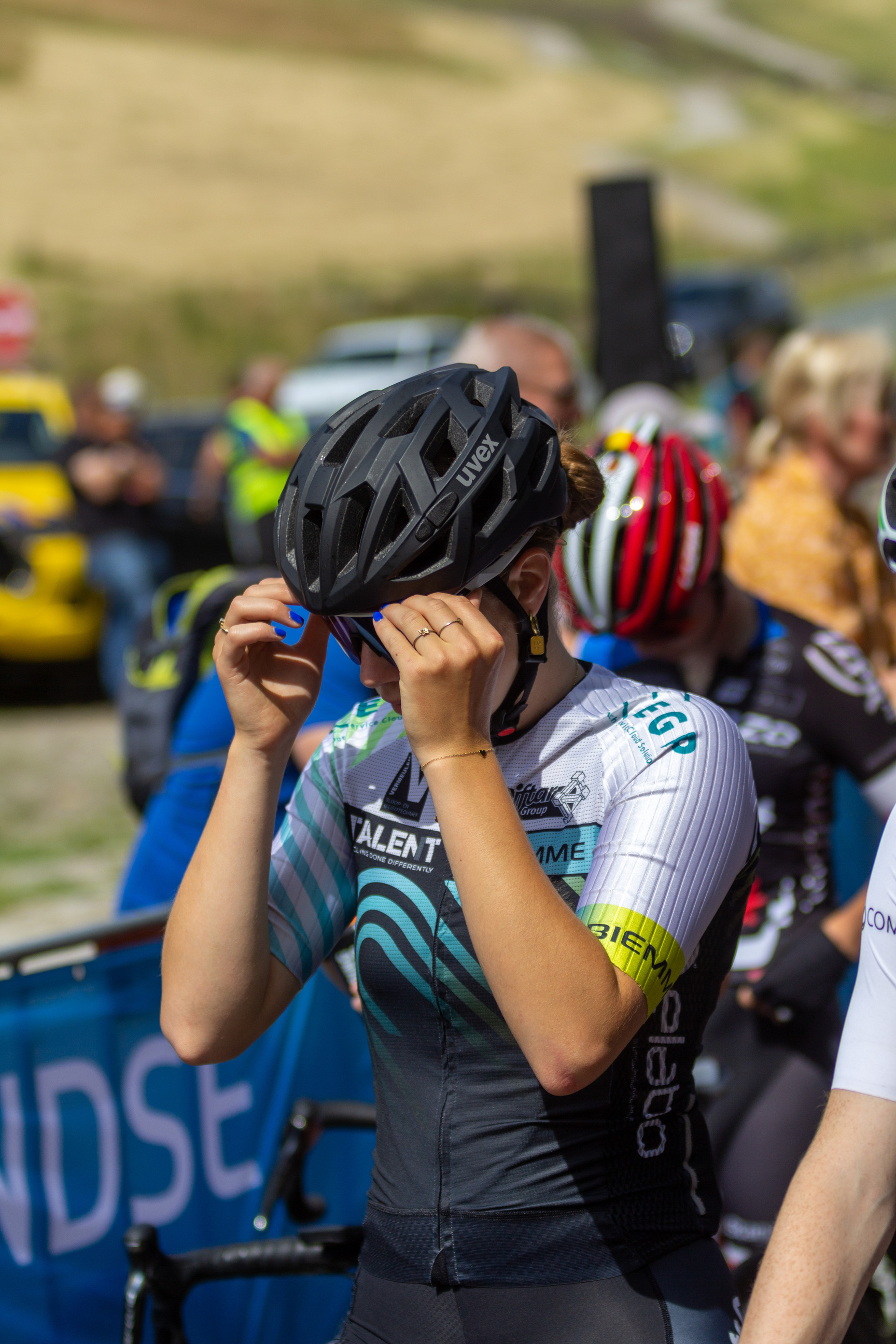 A woman in a bike racing event wearing the number 5.