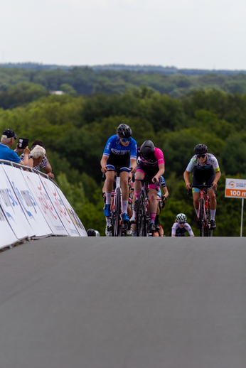 A group of people are racing bikes and the banner says "Junioren Dames".