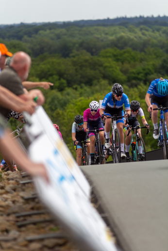 A group of cyclists, including a person in a blue jersey with the number 2 on it.