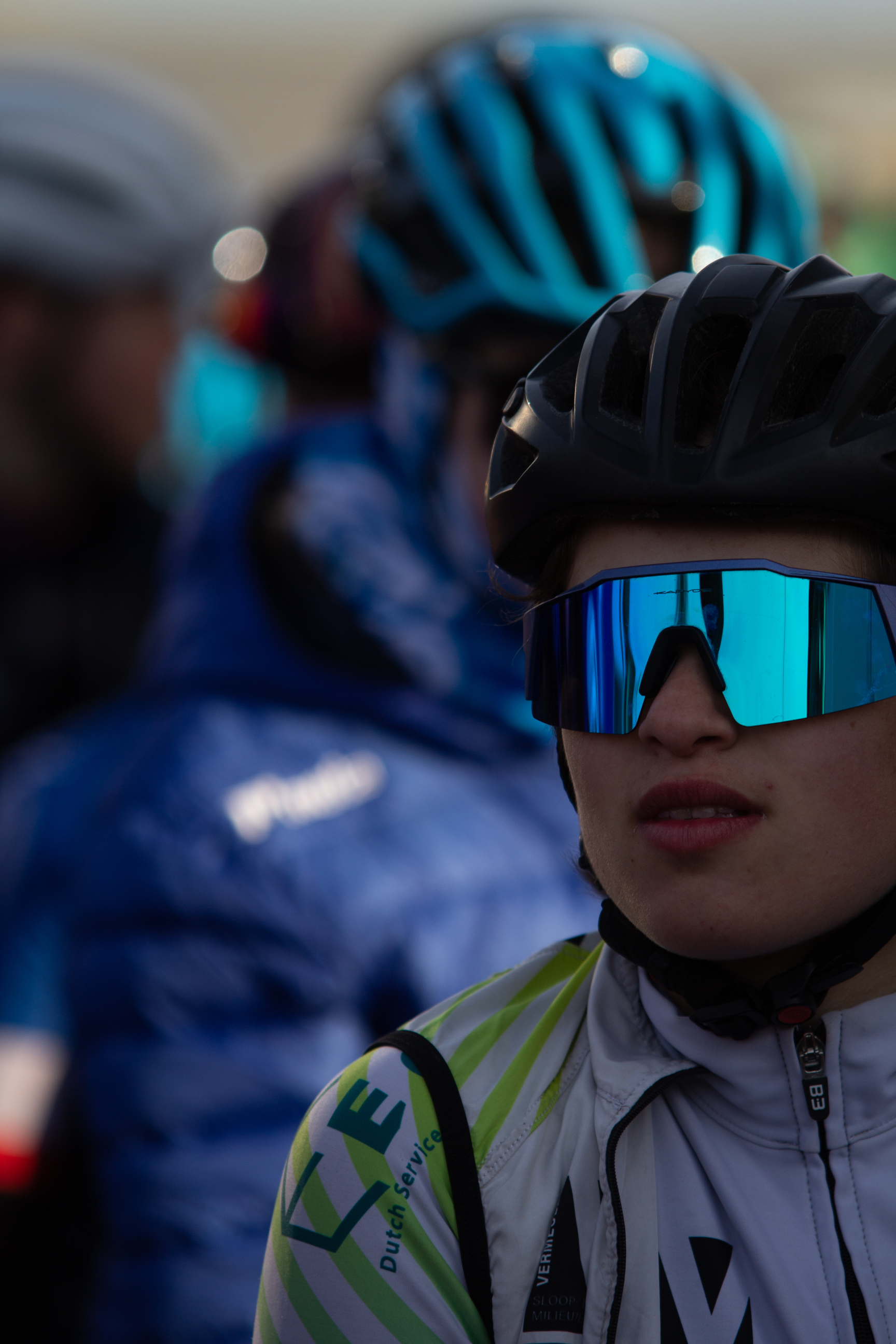 A person wearing a bike helmet with blue and black colors.