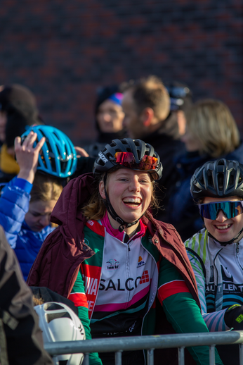 Two women wearing helmets, one with a pink jacket and the other with a blue one.