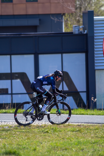 A cyclist is riding a black bike on a road in Overijssel, Netherlands.