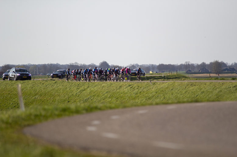 A group of bikers participate in a race at the Wielrennen Noord West Overijssel Dames event.