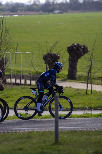 A man is racing on a bike in the Noord West Overijssel Dames.