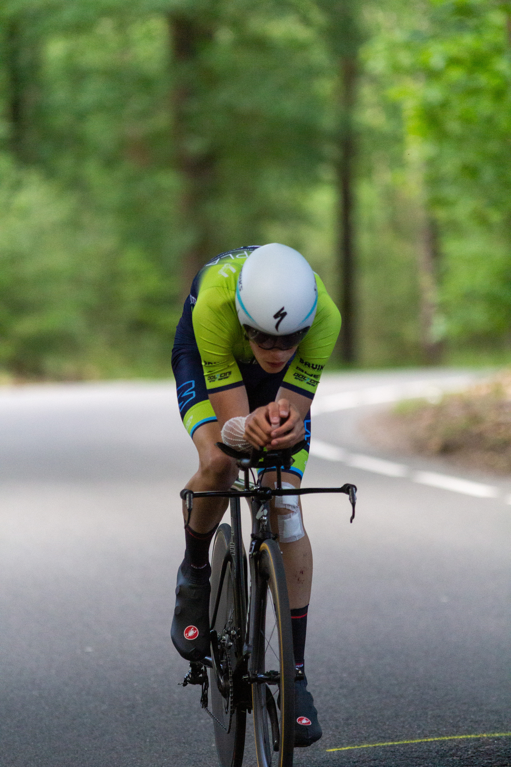 A cyclist wearing a helmet and a shirt with the number 1 on it.