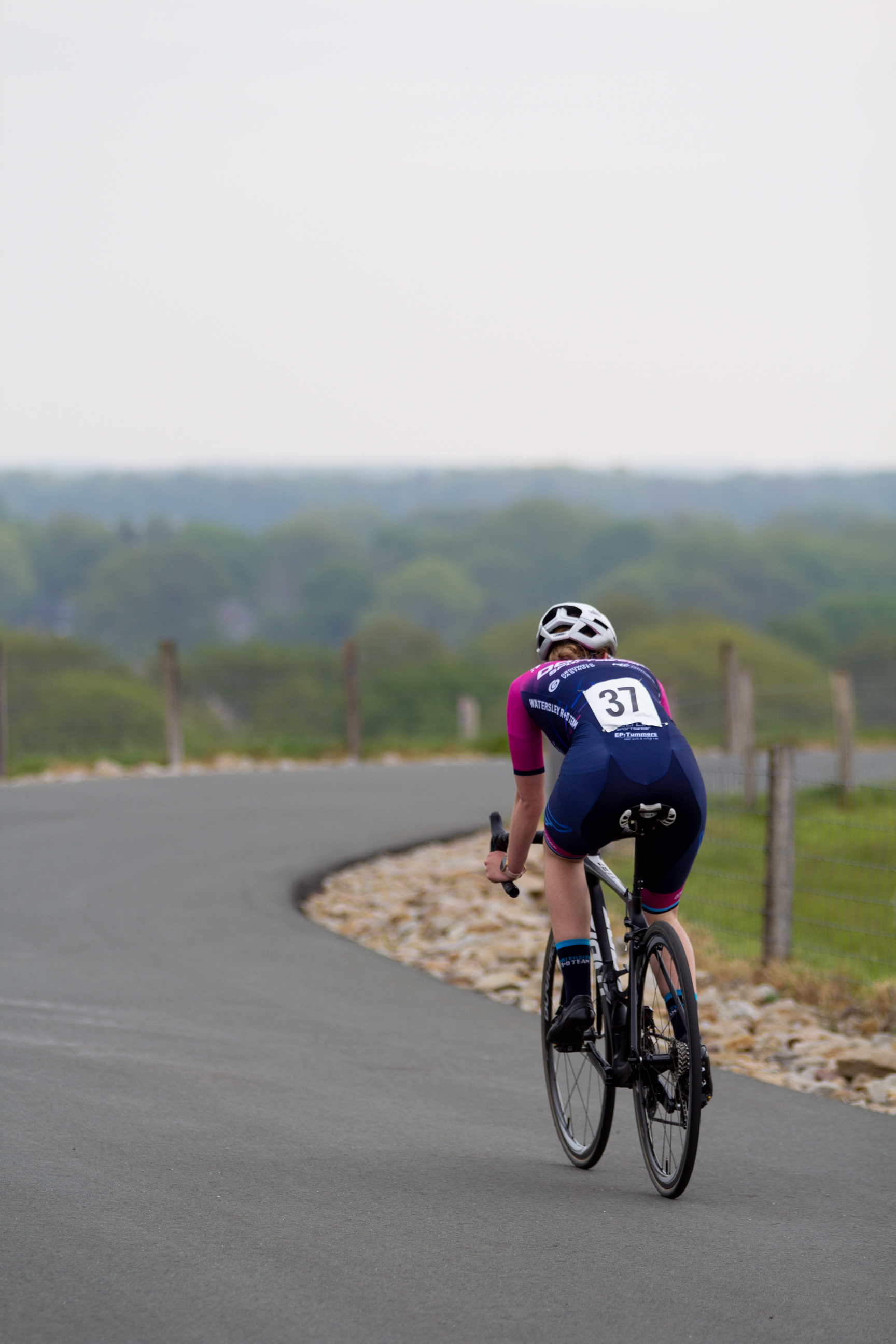 A cyclist in a blue uniform with the number 21 on the back.