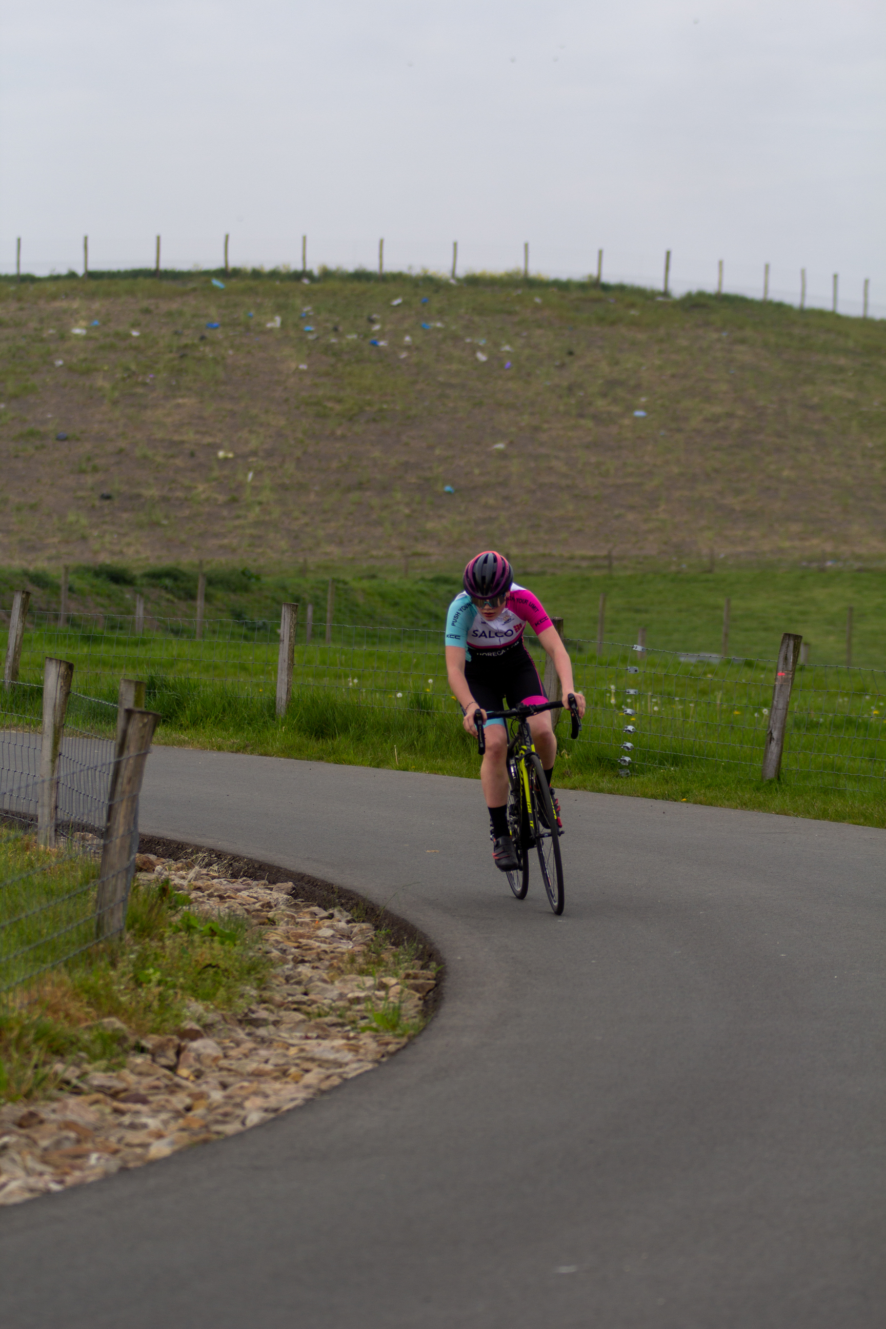 A woman on a bicycle with the words "Dames TT" written on her top.