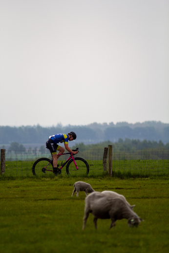 a picture of a cyclist in a blue jersey on a bicycle.