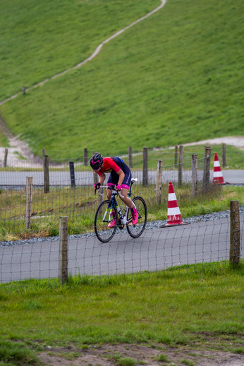 A woman racing on a bike in the grassy area during Dames TT.