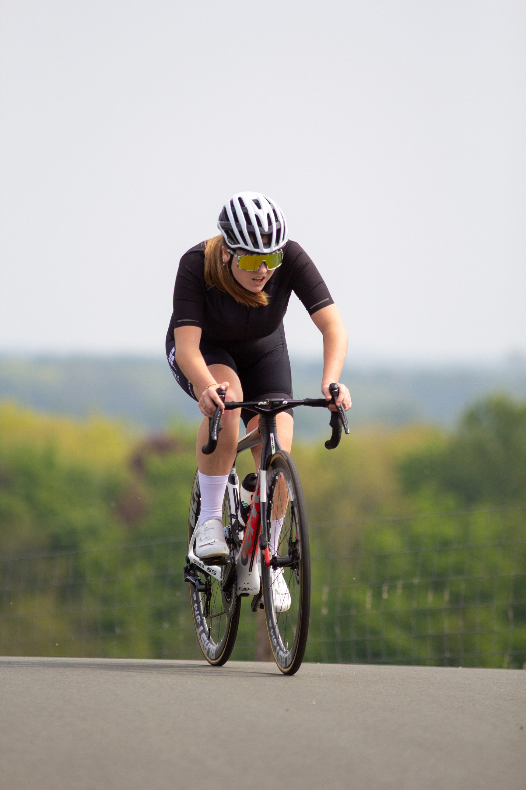 A woman is riding a bike during the Dames Criterium.