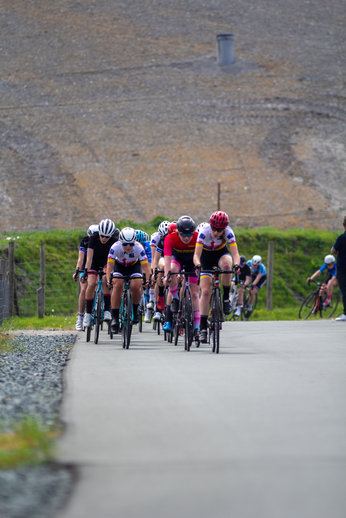 A group of cyclists are riding on a road during the Tweedaagse event.