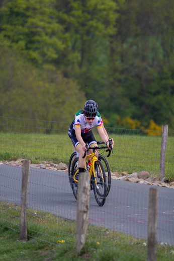 A woman is riding a bike with number 28 on the side.