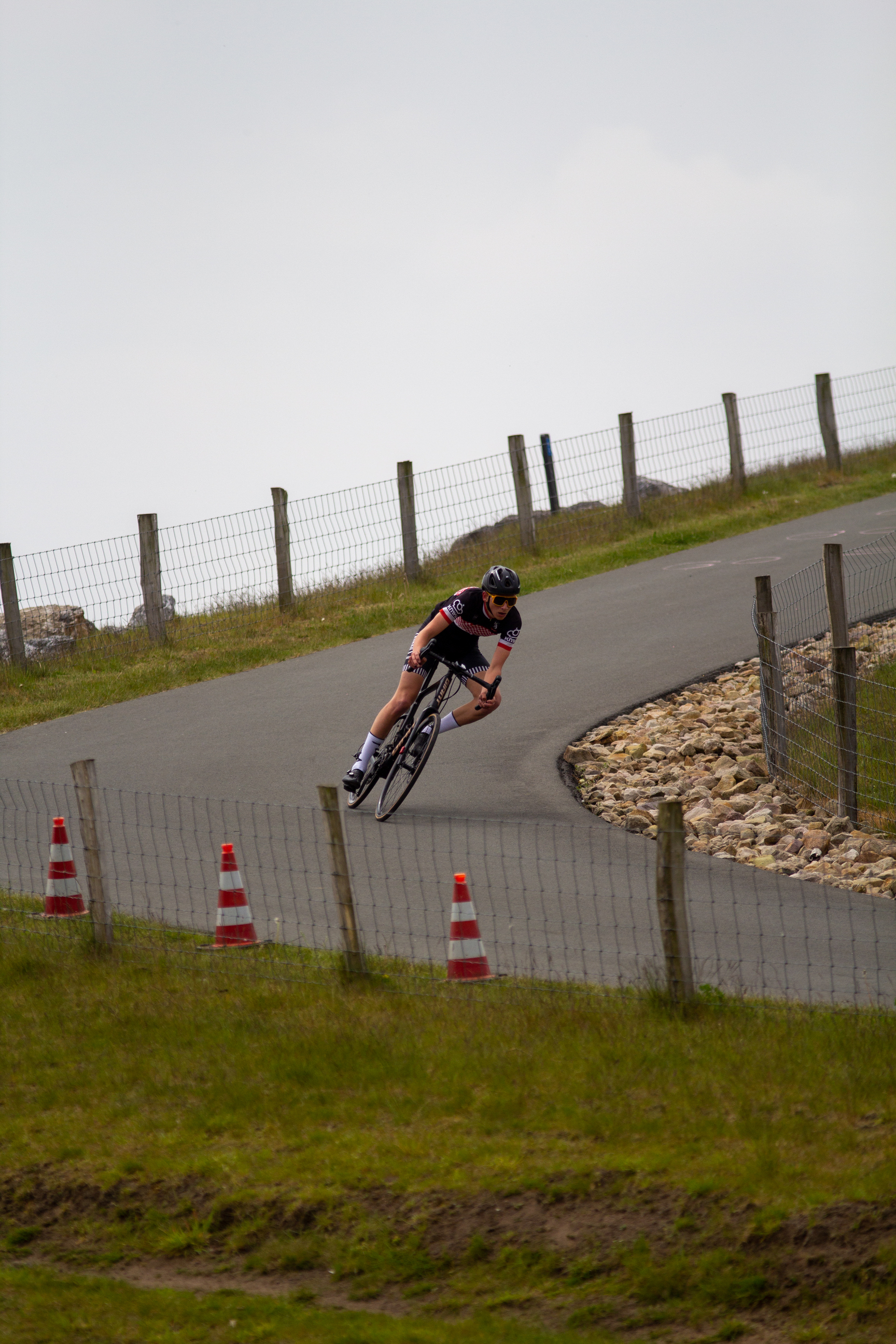 A cyclist wearing a black shirt and helmet on a mountain top.