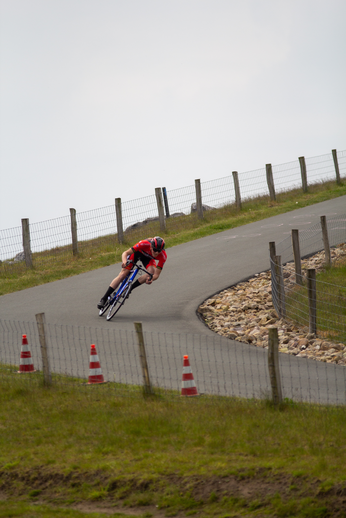 Rider on a bike going down a road in the country side.