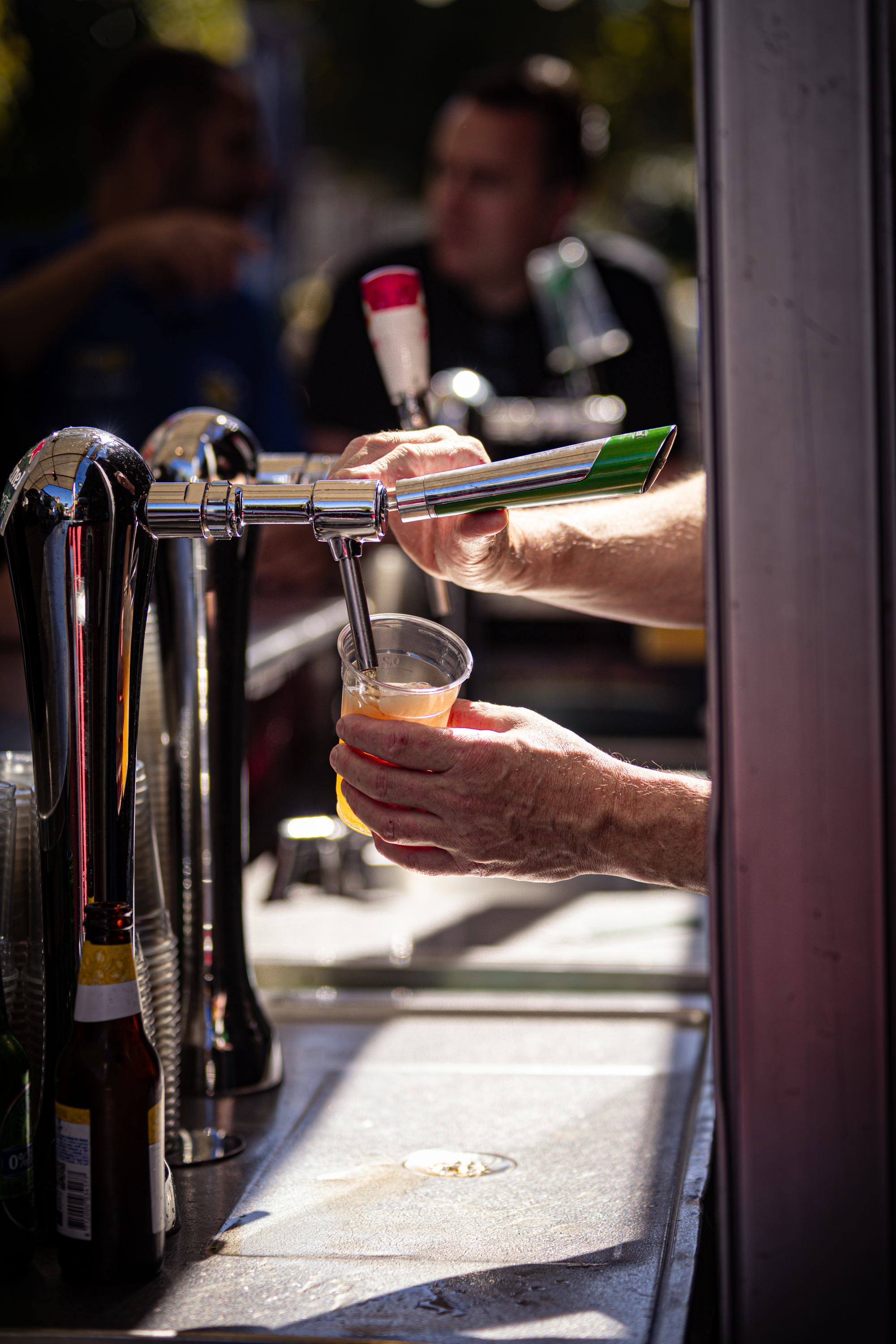 a man's hand pulling beer from a tap and the label on the bottle reads 'dierdke'.