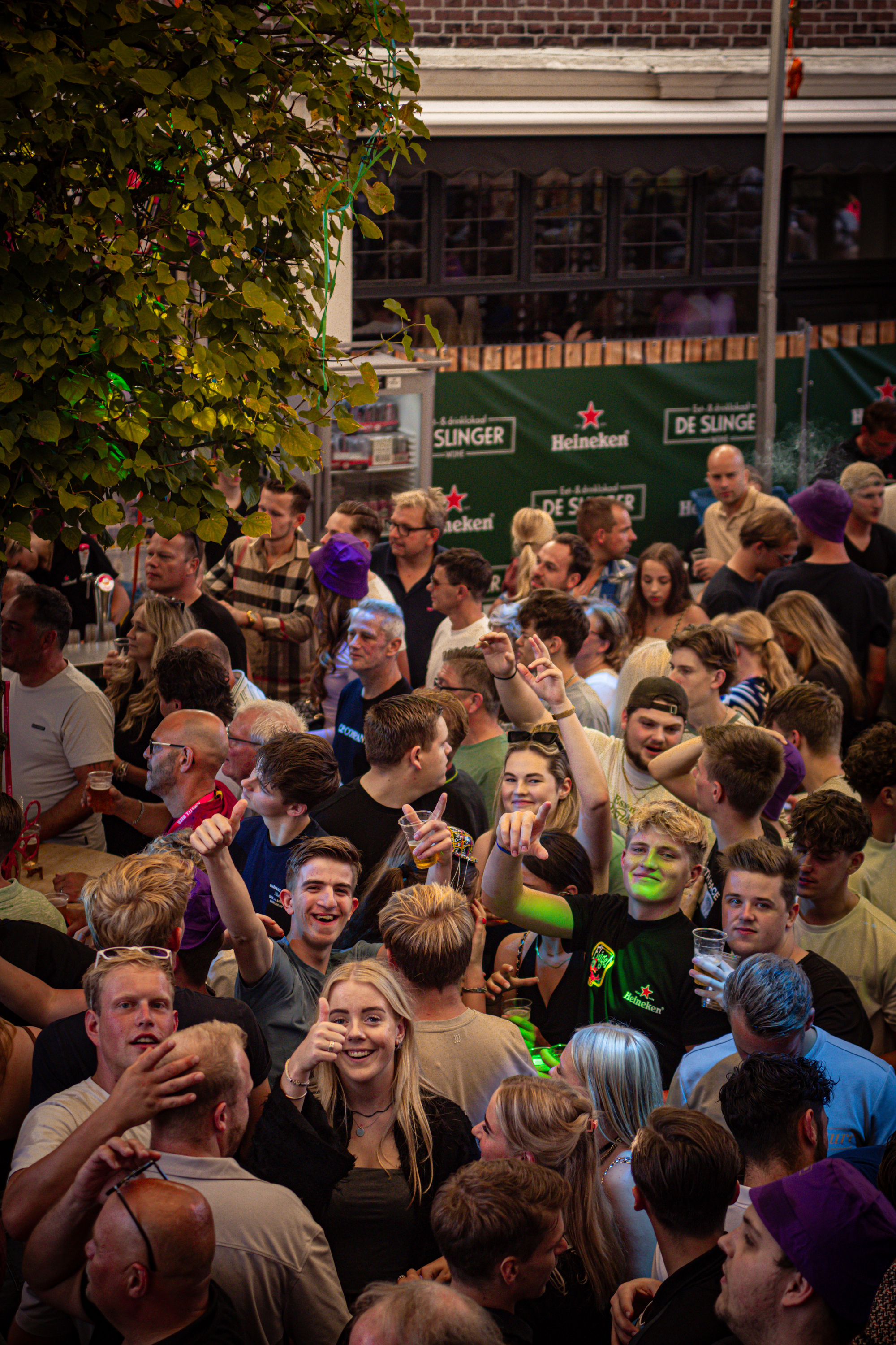 A crowd of people in a city park celebrating an event.