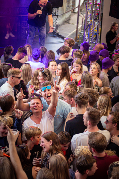 A group of people gathered around a stage at an event.