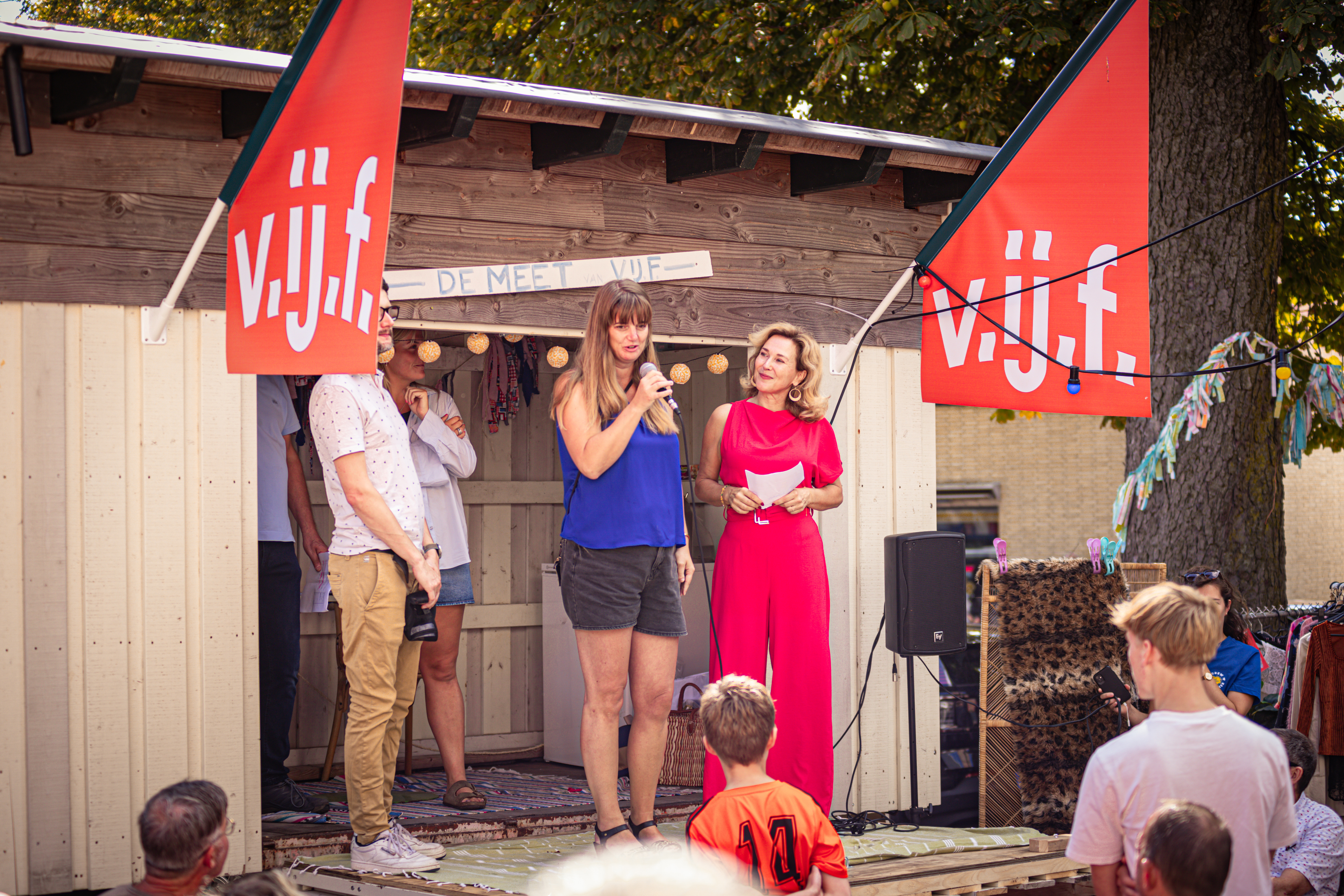 A group of people standing on a stage for the vijf festival.