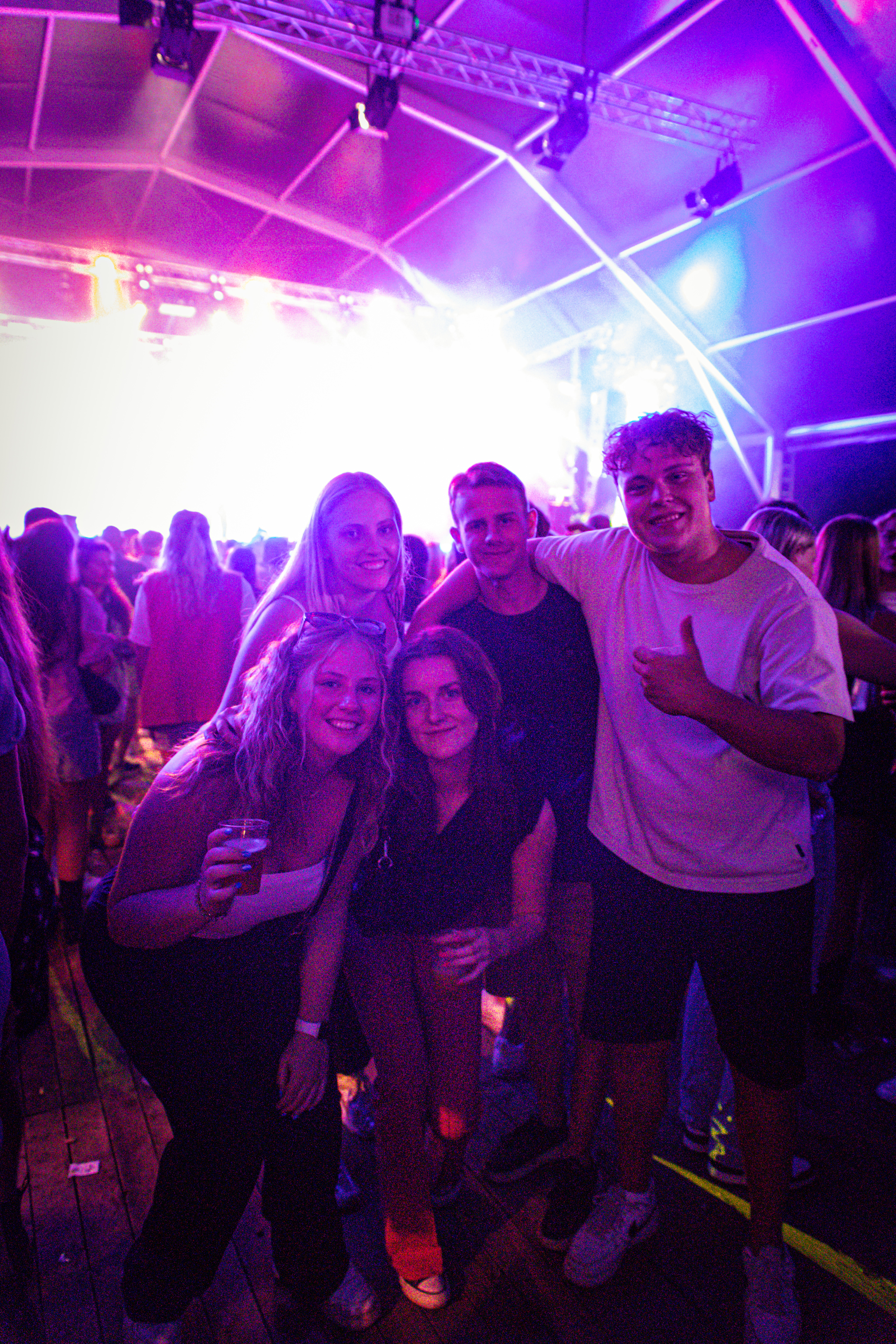 A group of people posing for a picture at a festival.