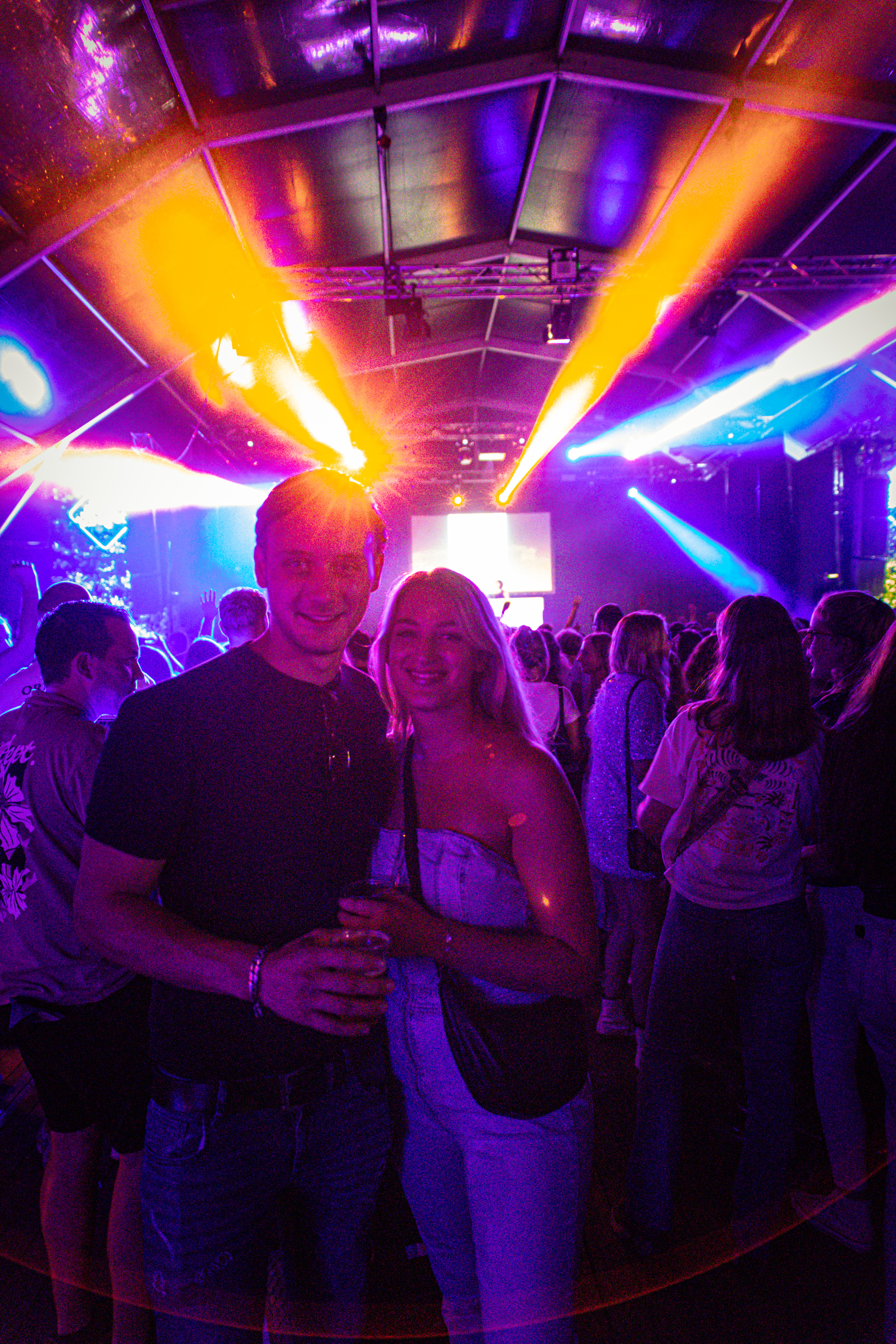 Two people standing next to each other, smiling at the camera.